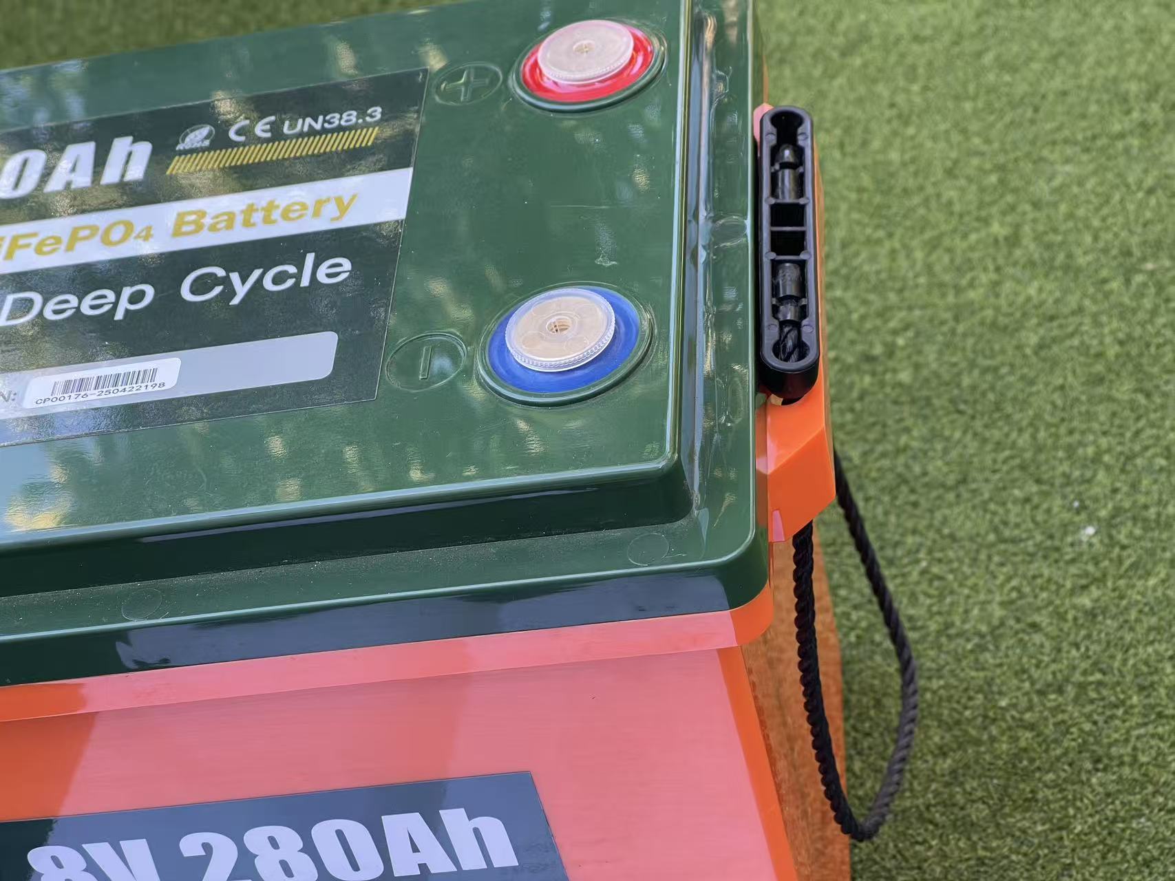 Top view of Kiwivolt 12.8V 280Ah lithium battery showing positive and negative terminals